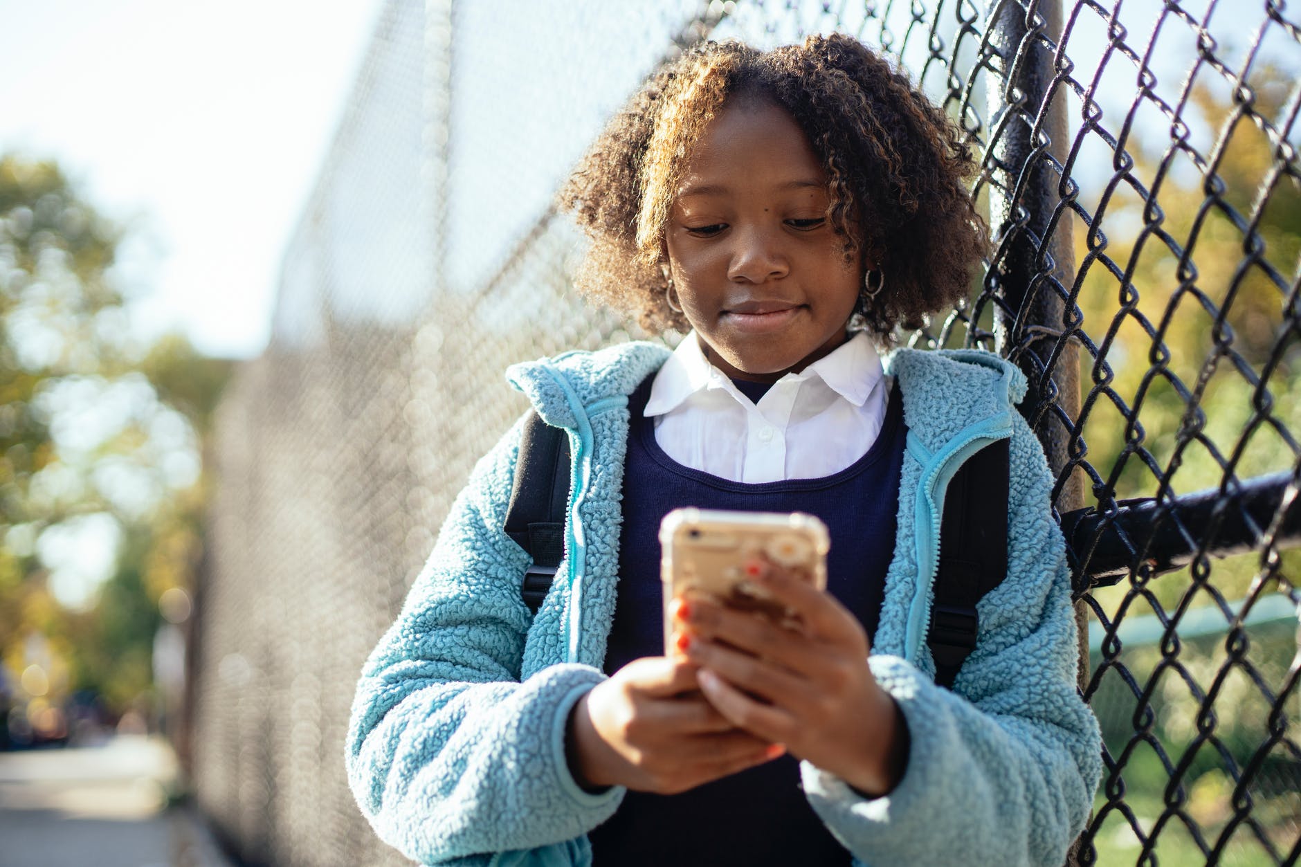 Young black girl using a phone